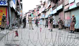 Security personnel on a Srinagar street to enforce curfew.
