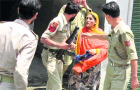 A woman argues with policemen during a demonstration in protest against the killings by the security forces in the past two months.