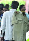 A policeman puts his vardi on his shoulder after calling it a day (or night) in New Delhi 