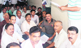 Teachers hold a protest at the office of the District Education Officer in Dehradun on Saturday.