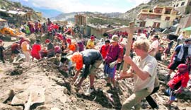 foreign tourists assist locals in removing debris in Leh.