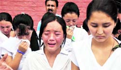 Students from Ladakh break down during a function at Government Girls Higher Secondary School in Jammu on Saturday.