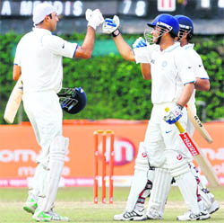 (L-R) VVS Laxman, Virender Sehwag and Suresh Raina celebrate after India won the third and final Test against Sri Lanka in Colombo on Saturday.