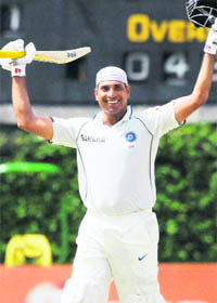 VVS Laxman celebrates his century on the fifth day of the final Test against Sri Lanka in Colombo on Saturday.