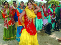 Girls performing a folk dance during the Teej mela organised in Bathinda on Sunday