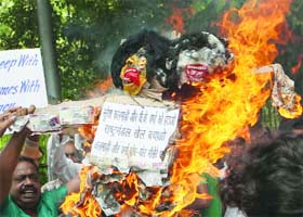 Jan Adhikar Morcha activists shout slogans, demanding the dismissal of corrupt OC officials in New Delhi