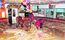 Army jawans clear the slash at Gurdwara Pathar Sahib near Leh on Sunday. 