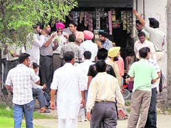 Teachers savour cold drinks from the only grocery shop located at Dana Mandi area on Sunday