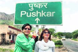 Former Union Minister of State for External Affairs Shashi Tharoor and friend Sunanda Pushkar pose before a sign board during their Ajmer visit on Sunday.