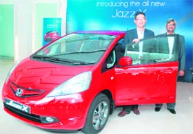 Tatsuya Natsume (L), Director (Marketing), Honda Siel Cars India Ltd, and Jnaneswar Sen, VP Marketing & Sales, pose with the "X" variant of Honda Jazz at its launch in Greater Noida