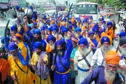 Nihangs belong to the Surjeet Singh faction taking out protest march againt the state government in Bathinda on Monday. 