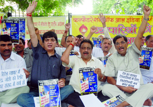 Members of the Confederation of All India Traders demonstrate against FDI Retail at Jantar Mantar in New Delhi on Monday.