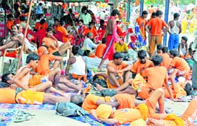 Kanwariyas rest at a camp in Haridwar