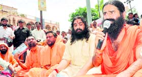 Yoga guru Swami Ramdev takes part in a dharna in Haridwar on Monday.