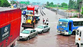 Commuters have a harrowing time manoeuvering their vehicles through accumulated rainwater near the Hero Honda chowk during a recent spell of rain in Gurgaon.