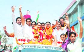 Newly appointed office-bearers of the Youth Congress, RS Pathania (second from left) and Vakar Rasool wave to their supporters after their arrival in Jammu