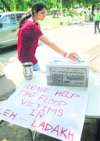 A student gives a donation for the Leh flood-affected in Jammu University