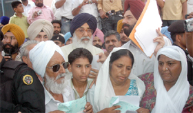 Punjab Chief Minister Parkash Singh Badal, with the family members of the Jogi Nagar blast victims, after handing over cheques to them in Bathinda on Tuesday.