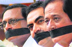 (From right) BJP leaders Harmohan Dhawan, Sanjay Tandon and Satyapal Jain sit on a silent protest in front of the CBI office, Sector 30, Chandigarh, on Tuesday