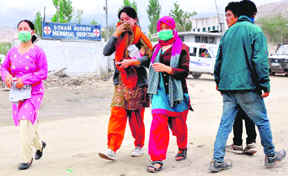 Anticipating the spread of diseases in the aftermath of the recent cloudburst, residents in Leh wear masks.