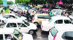 Vehicles caught in a traffic jam after rain on the Madhya Marg in Chandigarh on Wednesday