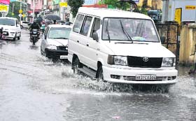 Vehicles pass through rainwater in Haridwar
