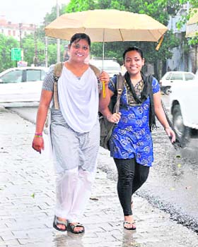 Two girls enjoy the rain in Haridwar