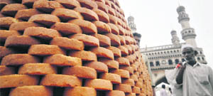 A man walks past mawa toast (of condensed milk, flour, sugar and salt) on sale ahead of the Muslim fasting month of Ramadan in Hyderabad.