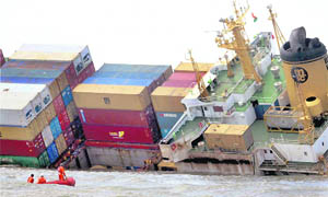 Coast Guard officials conduct a survey of Panamian ship MSC Chitra, which collided with another vessel four days back, off the Mumbai coast on Wednesday.
