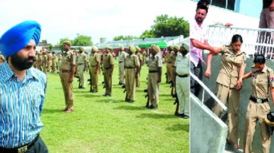 Bathinda SSP Dr Sukhchain Singh Gill inspecting the rehearsal for the Independence Day parade in Bathinda on Thursday; a woman cop (right) being taken to the hospital after she fainted during the rehearsal.