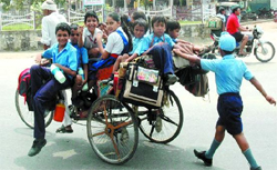 Oblivious of the risks involved, a rickshaw ferries school kids perched precariously in Bathinda