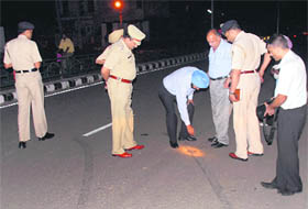 Police officials inspect the firing spot near Burail Jail on Thursday.