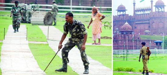 I-Day preparations: Security personnel lay roller truck for the vehicles of VIPs at the Red Fort in New Delhi on Thursday. A security guard keeps vigil