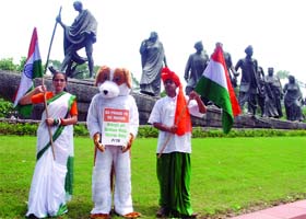 CANINE CARE: Members of the People for Ethical Treatment of Animals (PETA) appeal for adopting stray dogs at the Mahatma Gandhi statue in New Delhi