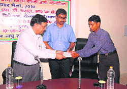 State Employment Department chief MP Bansal and DC A. Sriniwas (centre) hand over the appointment letter to a youth in Rewari.