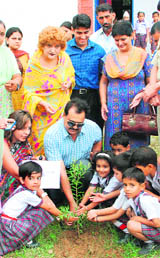 Ashok Gupta, IGP, plants a sapling in the presence of WWAO members at Handa College on Thursday.