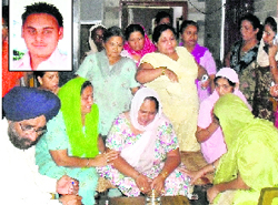 Relatives of Santosh Kaur (centre) gather at her house in Jawahar Nagar, Adampur, after her son Gagandeep Singh (inset) was kidnapped 