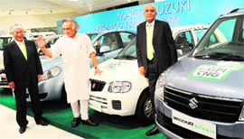 Environment and Forest Junior Minister Jairam Ramesh (C) speaks with Maruti Suzuki India CEO Shinzo Nakanishi (L) and chairman R.C. Bhargava (R) at the launch of new CNG engine technology in New Delhi on Friday.