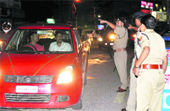Police personnel check a car on the Rajpur Road ahead of Independence Day celebrations in Dehradun