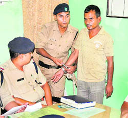 Sunil Valmiki, a wanted criminal, in police custody. 