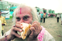 A sadhu on his way to Buddha Amarnath yatra blows a conch in Jammu.
