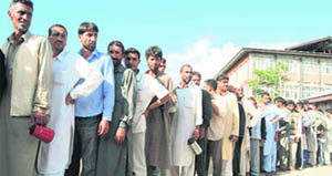 Attendants wait for their turn to get tea and snacks outside a hospital in Srinagar. Locals have been distributing food items among attendants of patients coming from far-off places in view of the restrictions in the Valley.