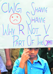 A boy holding a placard joins a recent protest by physically challenged athletes in front of Sports Minister M. S. Gills residence in New Delhi.