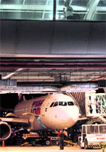 A TAM airlines plane is parked on the runway at Santos Dumont airport in Rio de Janeiro on Saturday. Brazil's largest airline TAM Linhas Aereas plans to merge with Chilean rival LAN, a deal that would create the biggest carrier in Latin America