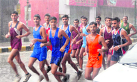 Participants brave heavy rain to participate in a cross-country race to mark Independence Day celebrations in Dehradun 