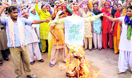 Members of the Midday Meal Workers Union burn an effigy of Education Minister Geeta Bhukkal in Rohtak on Saturday.