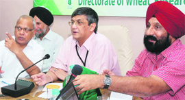 Union Agriculture Secretary PK Basu (centre) and other officials interact with farmers during a conference in Karnal on Saturday.