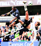 Tottenham Hotspur's Benoit Assou-Ekotto (L) challenges Manchester City's Carlos Tevez during their English Premier League soccer match at White Hart Lane in London on Saturday.