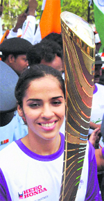 Badminton player Saina Nehwal holds the Queen's Baton for Commonwealth Games during its relay in Hyderabad on Saturday.