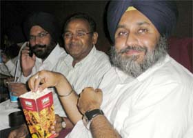 All work and no play makes Jack a dull boy! Deputy CM Sukhbir Badal ostensibly believes in this as he is seen enjoying popcorn while viewing a Punjabi film at Fun Cinemas in Bathinda